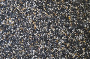 close up of charcoal exposed aggregate concrete